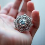 Main de femme tenant un bijou corse scintillant.